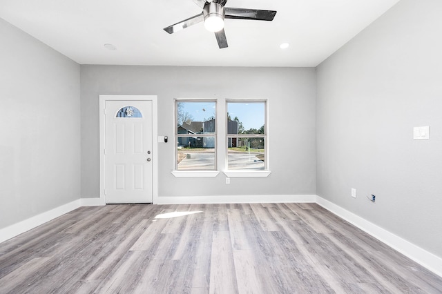 foyer with ceiling fan and light wood-type flooring