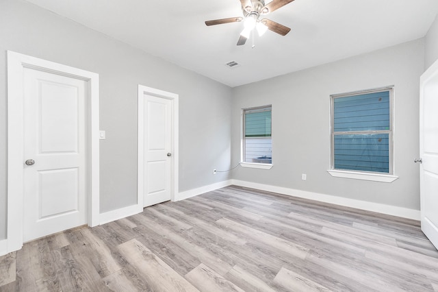 unfurnished bedroom featuring light wood-type flooring and ceiling fan