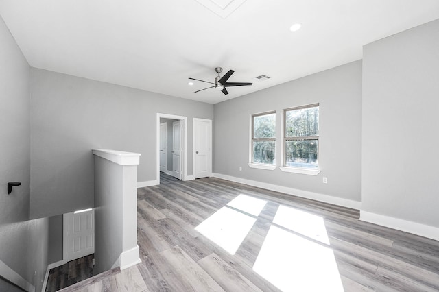 spare room featuring ceiling fan and light wood-type flooring