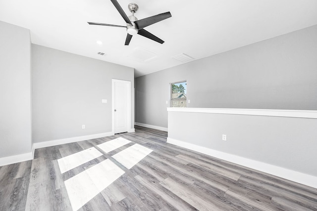 empty room featuring hardwood / wood-style floors and ceiling fan