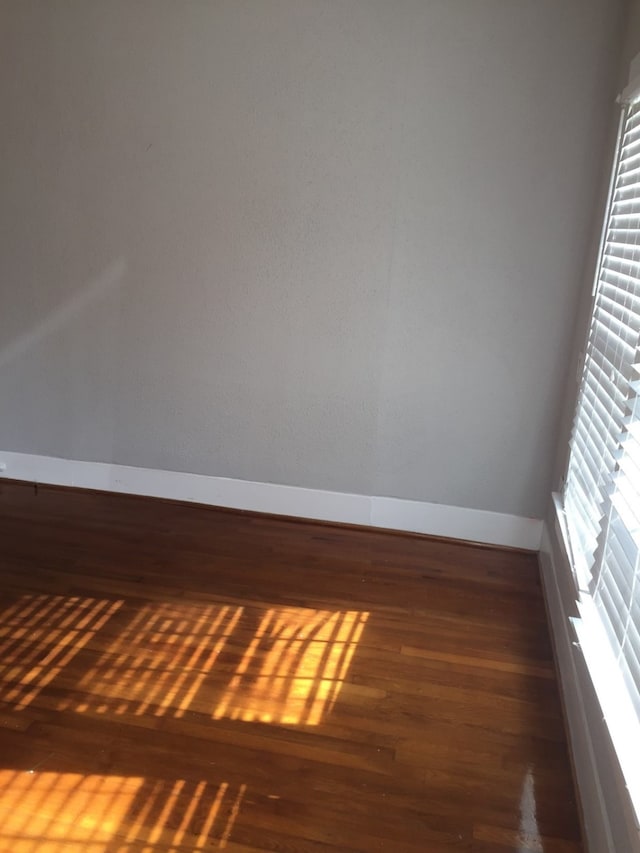 empty room featuring dark wood-type flooring