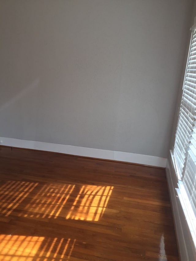 empty room with dark wood-type flooring