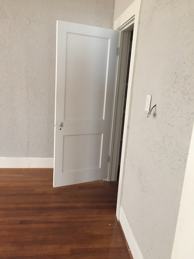 hall featuring dark wood-type flooring