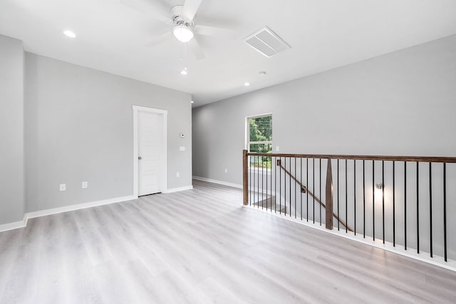 empty room featuring light wood-type flooring and ceiling fan