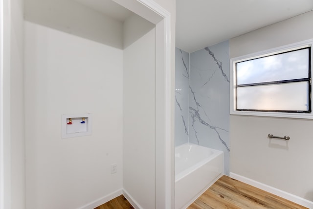 bathroom featuring hardwood / wood-style floors and a bathtub