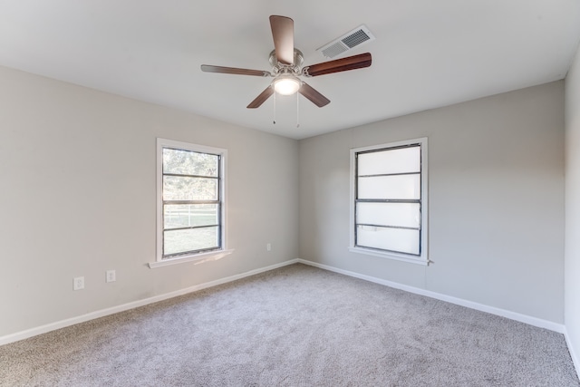 carpeted empty room featuring ceiling fan