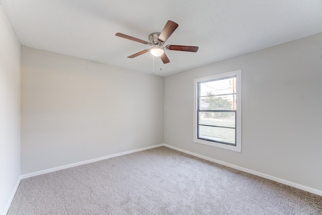 spare room featuring carpet flooring and ceiling fan