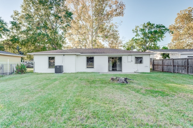 back of property with a lawn and cooling unit