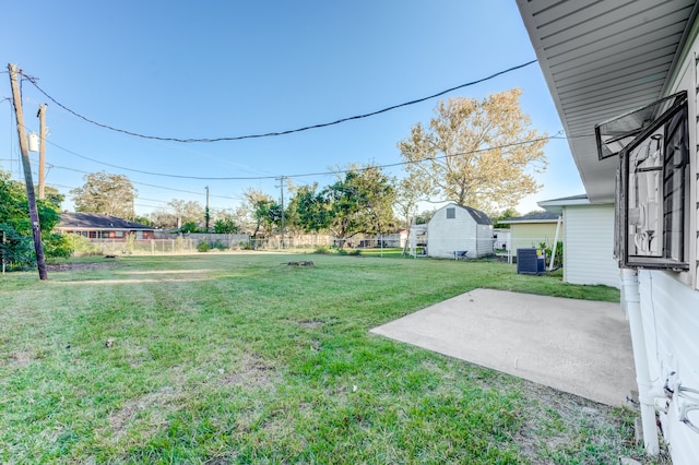 view of yard with central AC unit and a patio