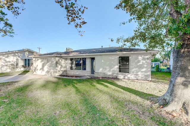 rear view of property with a lawn