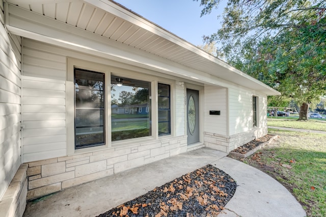 doorway to property with a yard