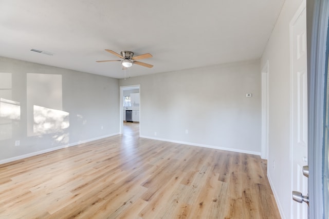 empty room featuring ceiling fan and light hardwood / wood-style floors