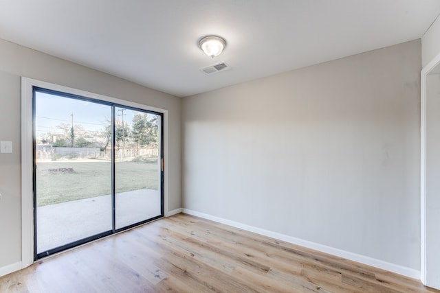 spare room with light hardwood / wood-style floors