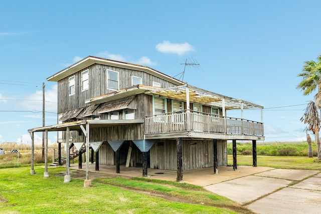 exterior space featuring a wooden deck and a front lawn