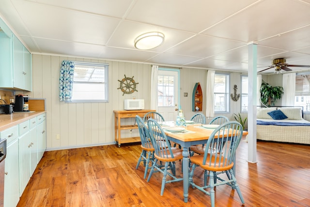 dining area with ceiling fan, plenty of natural light, and light wood-style flooring