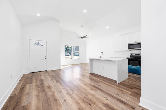 kitchen featuring white cabinets, a kitchen island with sink, light hardwood / wood-style floors, and stainless steel appliances