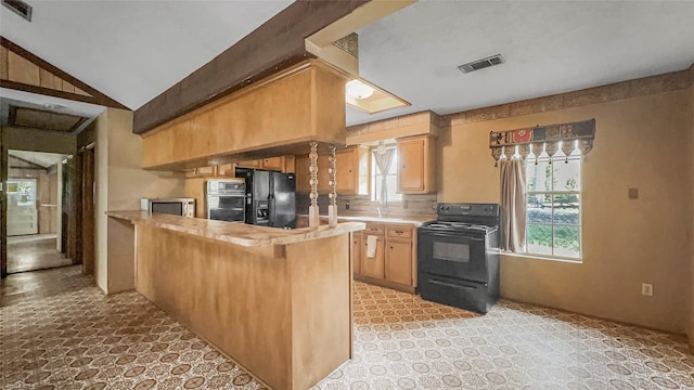 kitchen featuring kitchen peninsula, butcher block counters, black appliances, and lofted ceiling