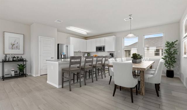 dining room with light hardwood / wood-style flooring