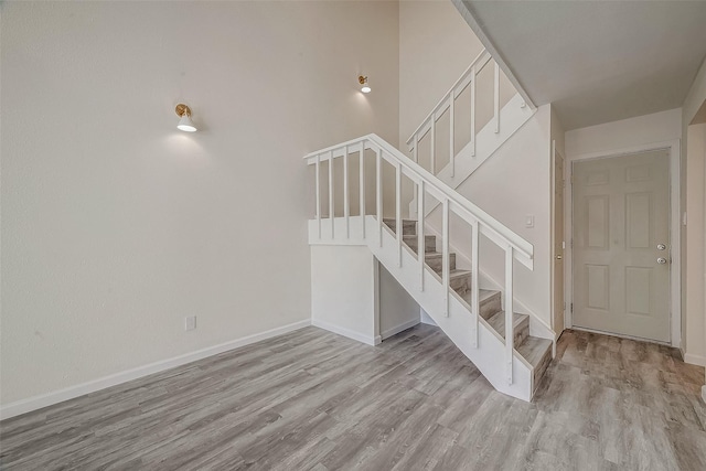 stairs with baseboards and wood finished floors