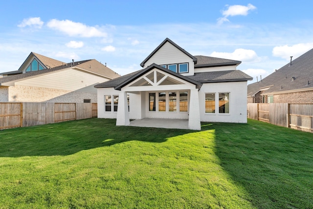 back of house featuring a patio and a yard