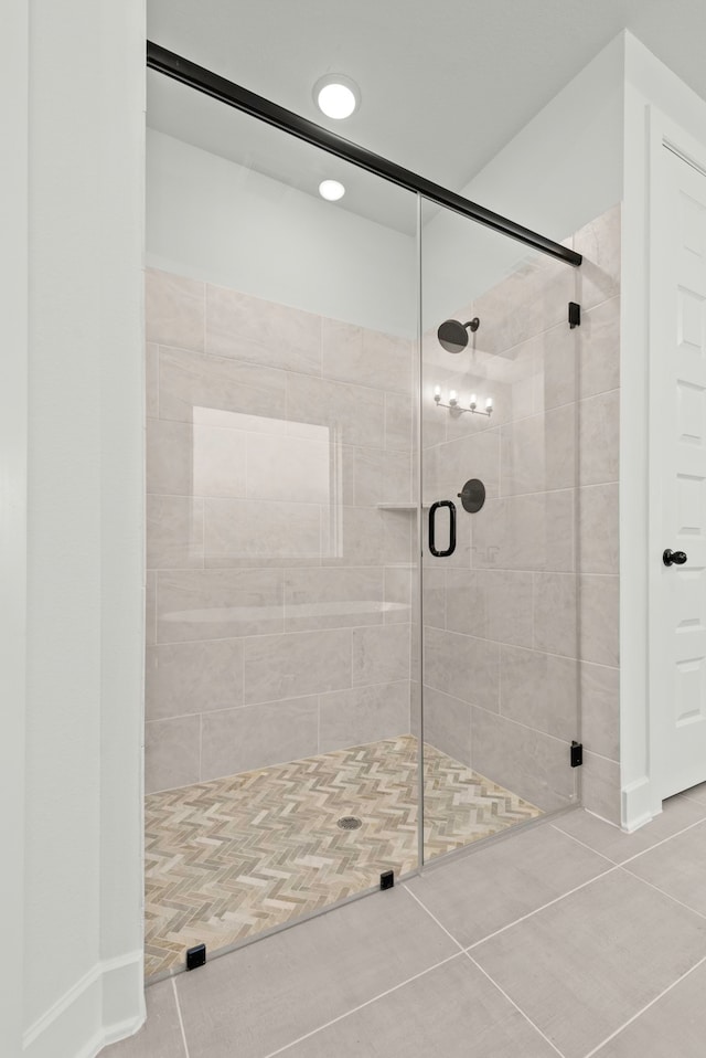 bathroom featuring tile patterned flooring and an enclosed shower