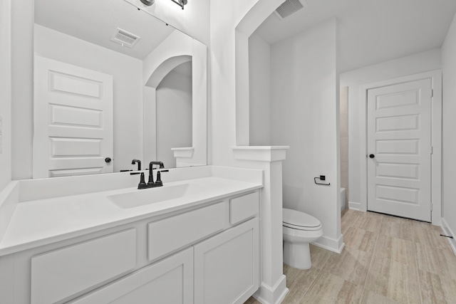 full bathroom featuring wood-type flooring, vanity, toilet, and shower / washtub combination