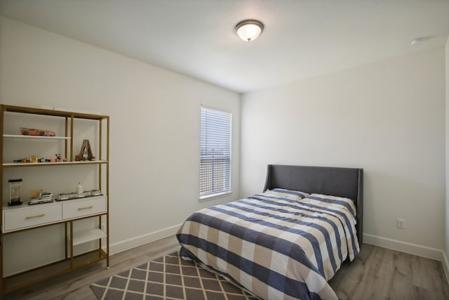 bedroom with hardwood / wood-style floors