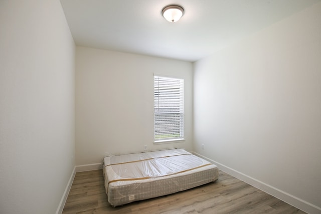 bedroom with wood-type flooring