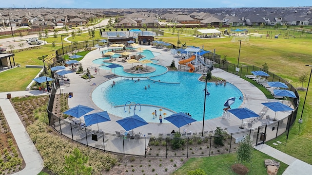 view of swimming pool with a lawn