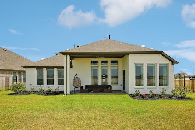 back of house featuring ceiling fan, a yard, and an outdoor hangout area