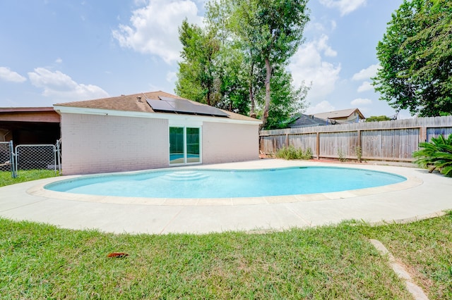 view of pool with a lawn