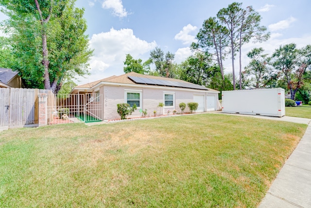 ranch-style house with solar panels, a front lawn, and a garage