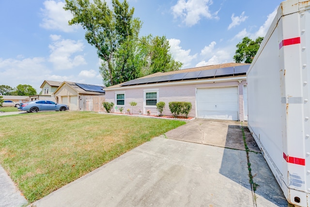 ranch-style house with solar panels, a front lawn, and a garage