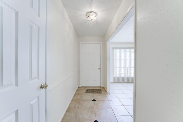 entryway featuring a textured ceiling and light tile patterned flooring