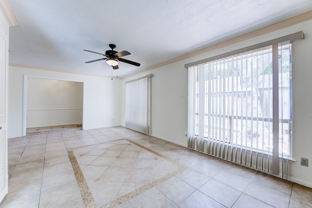 tiled empty room with ornamental molding and ceiling fan