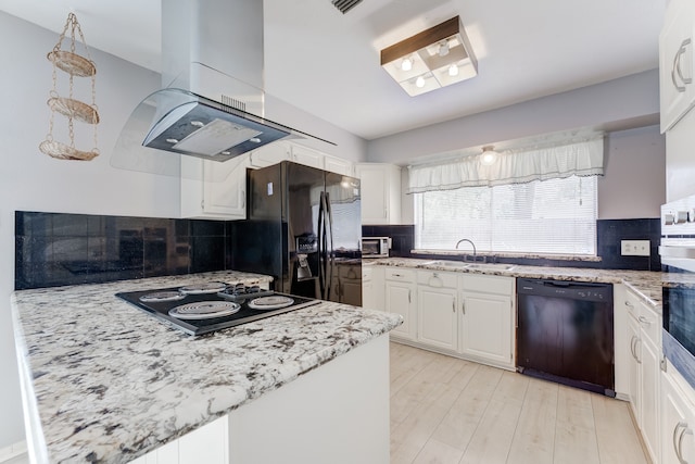 kitchen featuring black appliances, island range hood, sink, decorative backsplash, and white cabinets