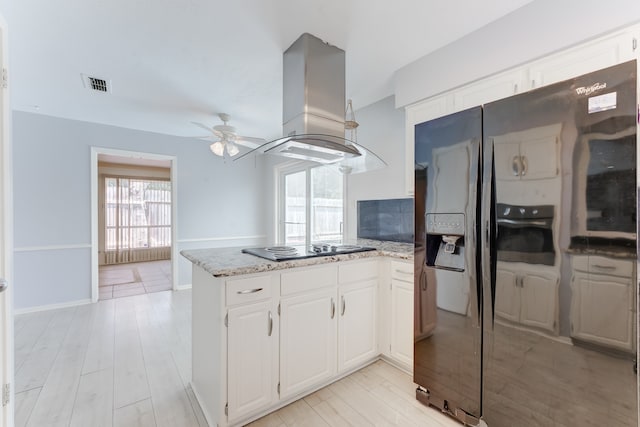 kitchen with island range hood, white cabinetry, black electric cooktop, and plenty of natural light