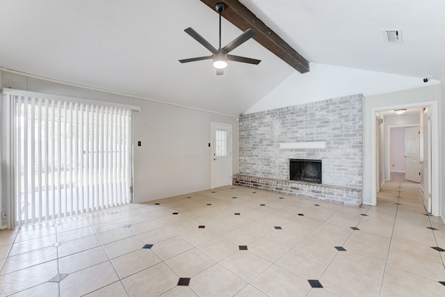 unfurnished living room with lofted ceiling with beams, light tile patterned floors, ceiling fan, and a brick fireplace