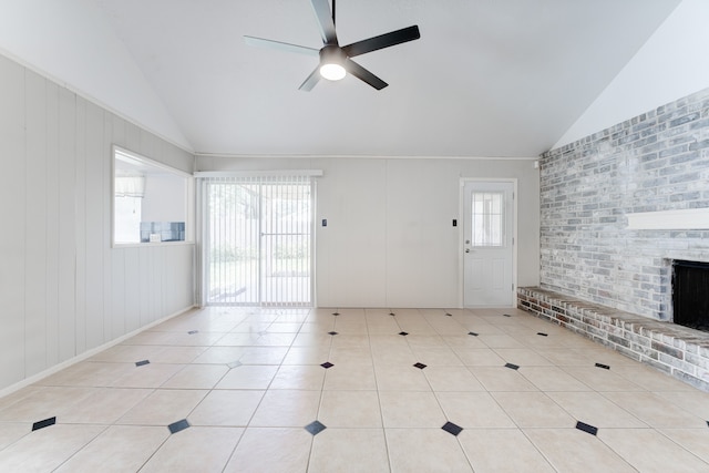 unfurnished living room featuring vaulted ceiling, light tile patterned floors, ceiling fan, and a brick fireplace