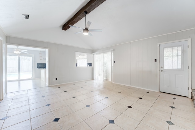 interior space featuring a wealth of natural light, ceiling fan, and vaulted ceiling with beams