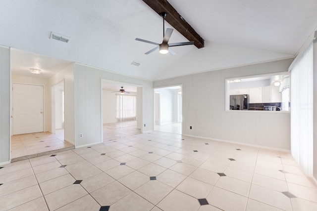 tiled empty room with vaulted ceiling with beams and ceiling fan