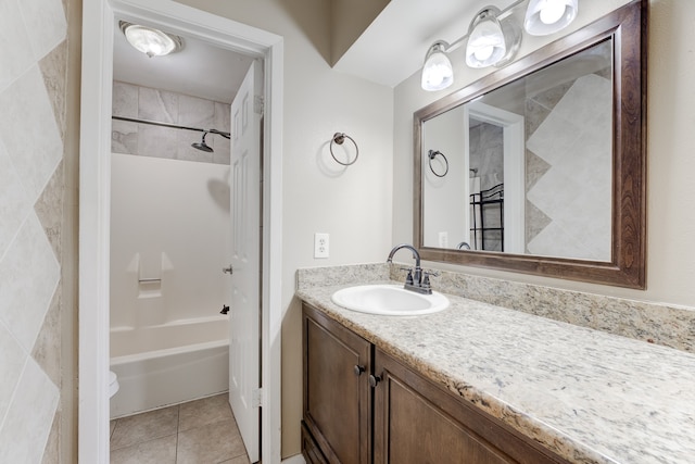 full bathroom with tiled shower / bath, vanity, toilet, and tile patterned floors