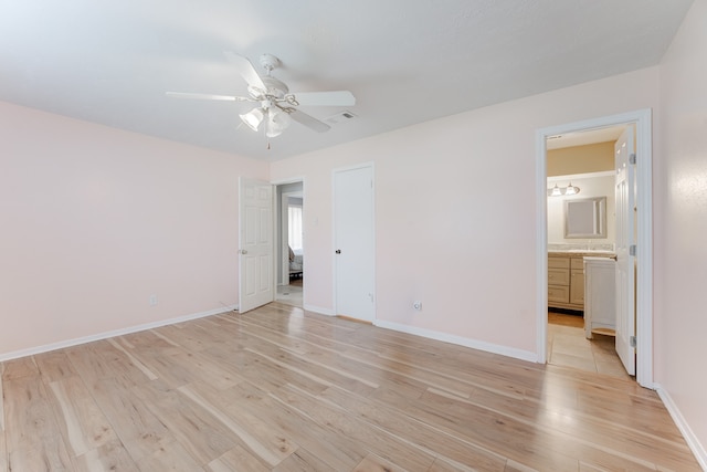 unfurnished bedroom with ensuite bathroom, ceiling fan, and light hardwood / wood-style flooring