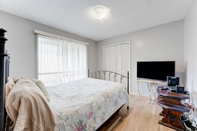 bedroom with a closet and light wood-type flooring