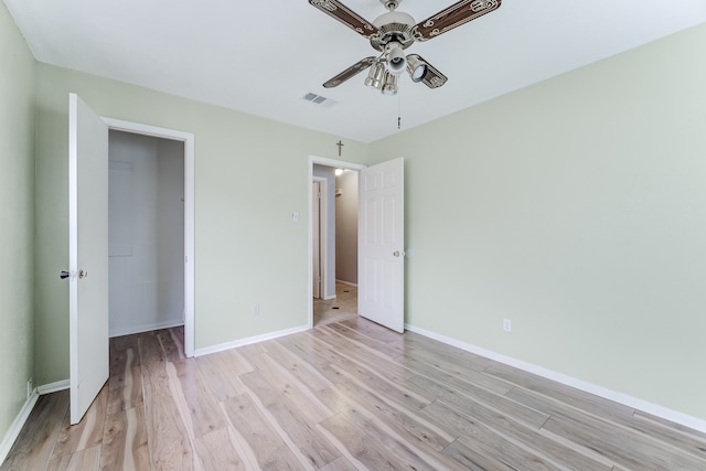 unfurnished bedroom with ceiling fan, a closet, and light hardwood / wood-style flooring