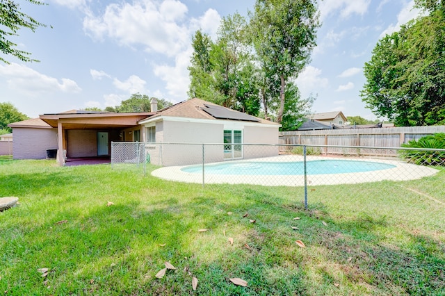 view of pool with a lawn