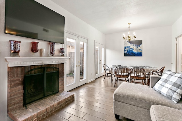 living room with a brick fireplace, french doors, and a healthy amount of sunlight