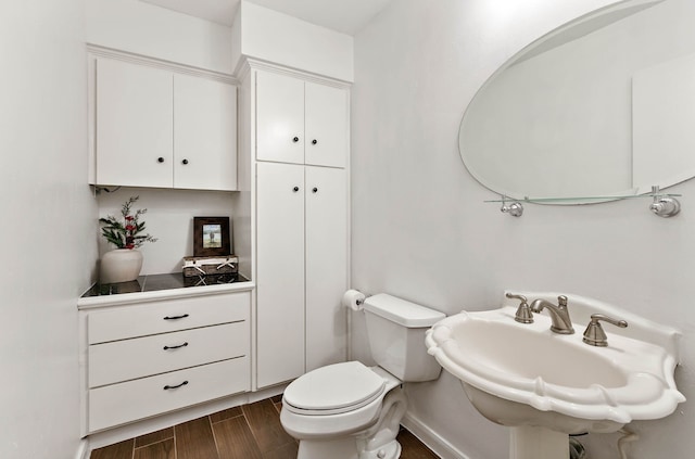 bathroom featuring hardwood / wood-style floors, sink, and toilet