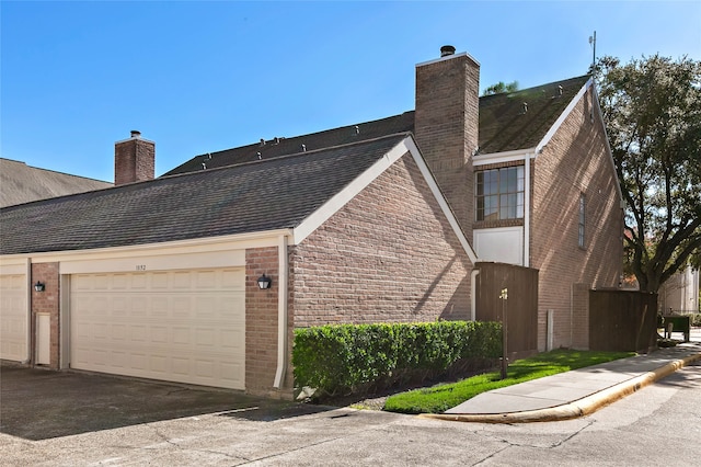 view of side of home featuring a garage