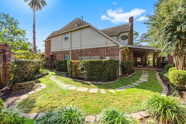 view of side of property with a lawn and a patio